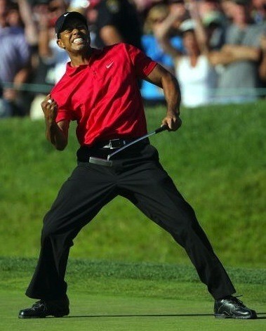 Tiger Woods pumping his fist after sinking a putt on the 72nd hole of the 2008 US Open to tie Rocco Mediate for the lead.